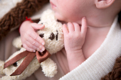 baby holding knitted bunny