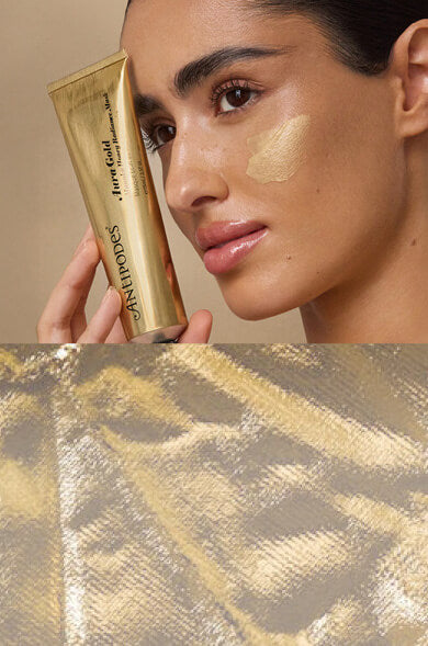 Woman applying gold-colored cream to her face with a tube labeled 'Lancé' in the background.