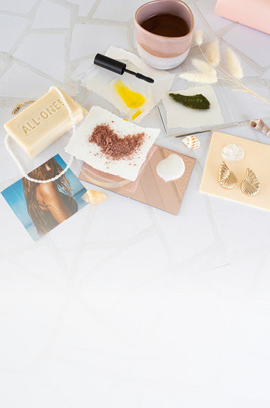 Bar of soap, coffee cup, and small items on a white surface