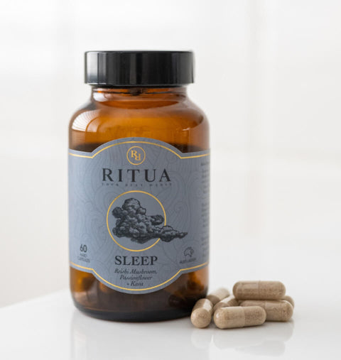 Bottle of Ritua Sleep supplements with capsules on a white background