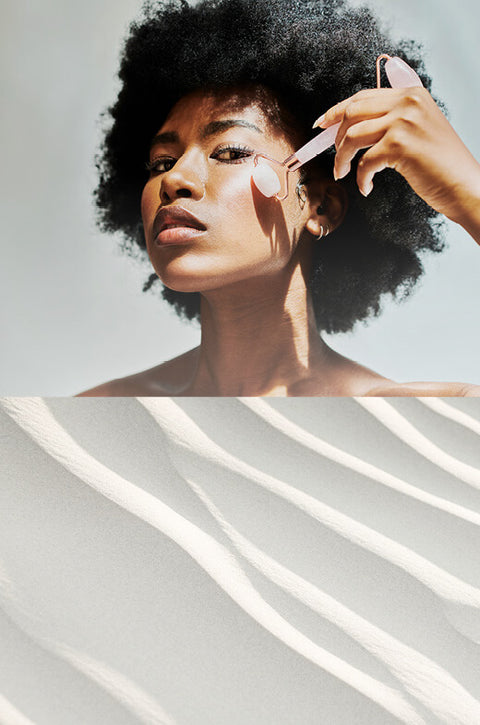Woman applying skincare product with a brush on a light background