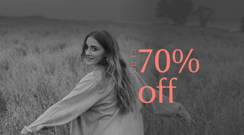 Woman in a field with '70% off' text overlay