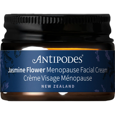 A jar of Antipodes Jasmine Flower Menopause Facial Cream with a black ribbed lid, dark amber glass jar, and a navy blue label with white text.