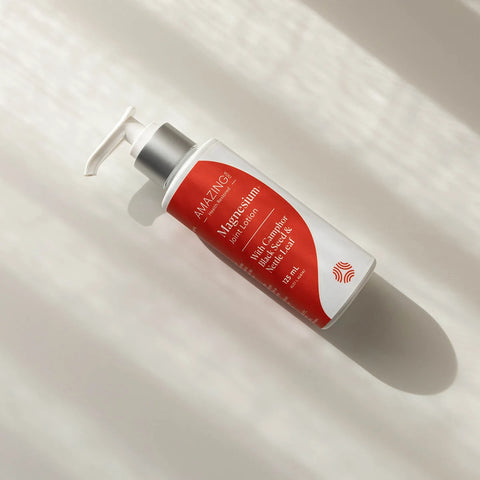 Amazing You Magnesium Joint Lotion bottle with red label on a light background. With camphor, black seed & nettle leaf.