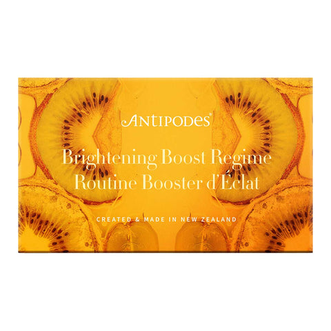 Antipodes Brightening Boost Regime skincare set packaging with kiwi fruit design on a yellow background.