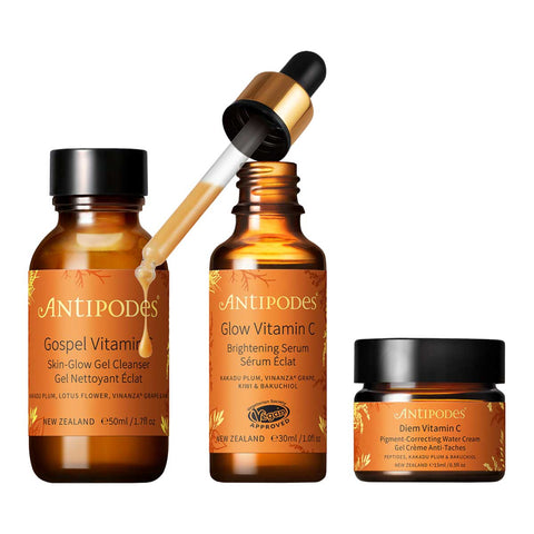 Antipodes Brightening Boost Regime skincare set products including a serum, cleanser, and cream on a white background.