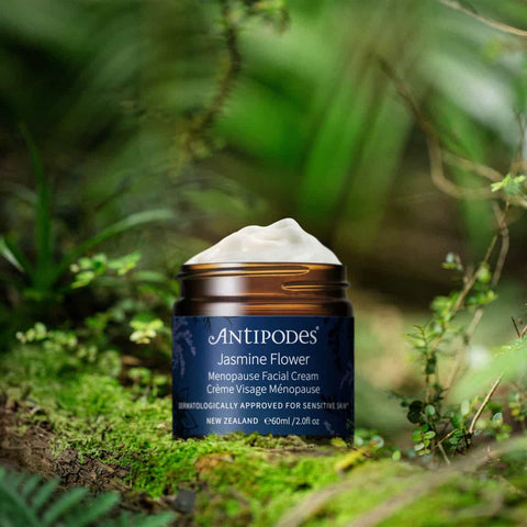 Antipodes Jasmine Flower Menopause Facial Cream jar on a natural green background