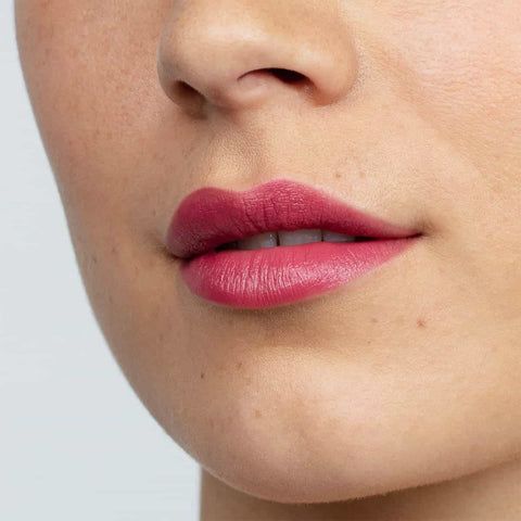 Remarkably red lipstick swatch on a person's lips.