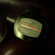Antipodes Mánuka + Orange Volume & Shine Shampoo bottle on a dark background.