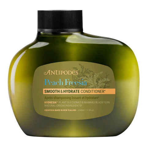 Antipodes Peach Freesia Smooth & Hydrate Conditioner bottle on a white background.