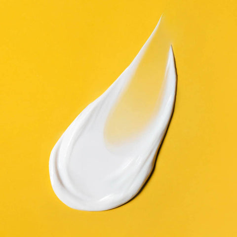 Swatch of silky smooth antipodes supernatural spf50 ceramide silk sunscreen on a yellow background.