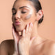 Model wearing a swatch of bronzer on her cheek on top of make up.