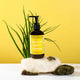Bottle of tallow body lotion on a white surface with a yellow background