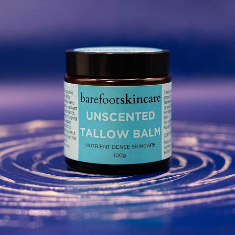 Barefoot Skincare Unscented Tallow Balm jar on a blue and purple gradient background