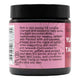 Pink jar with black lid containing balm, featuring product information and health benefits on a white background