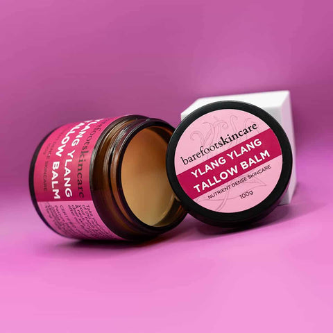 Ylang Ylang Tallow Balm jar and packaging on a pink background