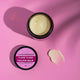 Ylang Ylang Tallow Balm jar with lid on a pink background with a swatch shown.