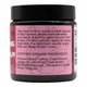 Back of tallow balm jar with pink label with usage instructions and ingredients on a white background