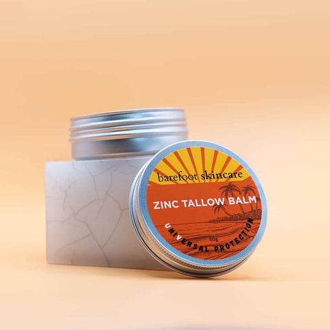 Barefoot Skincare Zinc Tallow Balm with packaging on a beige background