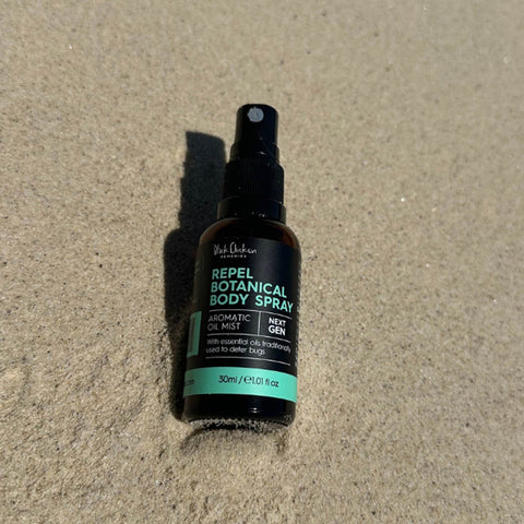 Repel Botanical Body Spray bottle on sand
