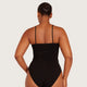 Boody Base Layer Cami Top Black lifestyle back view of a woman with her hair up wearing the black cami and briefs, styled lifestyle photo
