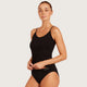 Boody Base Layer Cami Top Black lifestyle shot of a woman with her hair up in the black cami and briefs, hands at her waist, styled lifestyle photo