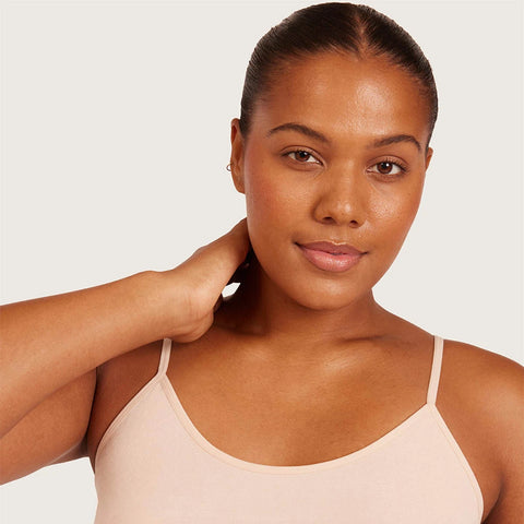 Boody Base Layer Cami Top Nude lifestyle close up of a smiling woman with her hand at her neck wearing the nude cami, styled lifestyle photo