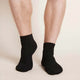 Black unisex ankle socks worn by a man.