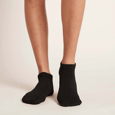 Black unisex ankle socks worn by a woman.