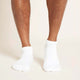 White unisex ankle socks worn by a man.