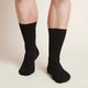 Black everyday crew socks worn by a man.