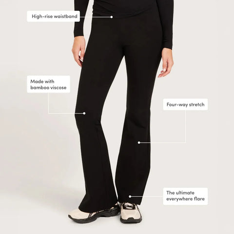 Black high-rise flare pants shown on a model from the waist down, with text callouts highlighting features.