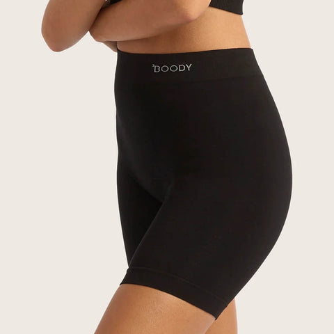 Boody Seamfree Undershorts 6 inch Black lifestyle side view of a person's hips wearing the black shorts with the Boody logo on the waistband