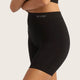 Boody Seamfree Undershorts 6 inch Black lifestyle side view of a person's hips wearing the black shorts with the Boody logo on the waistband
