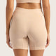 Boody Seamfree Undershorts 6 inch Shell lifestyle back view of a person wearing the pale pink nude shorts, styled lifestyle photo
