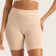 Boody Seamfree Undershorts 6 inch Shell lifestyle close up of a person's torso wearing the pale pink nude shorts with a hand on the hip