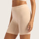 Boody Seamfree Undershorts 6 inch Shell lifestyle side view of a person wearing the pale pink nude shorts, close up of the fit