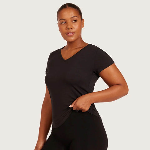 Boody Women's Base Layer V-Neck T-Shirt Black lifestyle shot of a woman in the black v-neck tee, turned slightly to the side, styled lifestyle photo