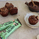 Chocolate muffins with Chief Collagen protein bars on a countertop.