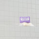 Lavender magic bar soap with a purple label on a tiled bathroom wall.