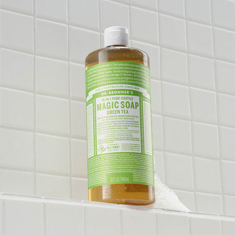 Bottle of Dr. Bronner's Magic Soap Green Tea on a tiled bathroom shelf