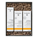 A Dr. Hauschka gift set containing three skincare bottles (Soothing Cleansing Milk, Facial Toner, and Hydrating Serum Plus) in a black box filled with brown shredded paper packaging.