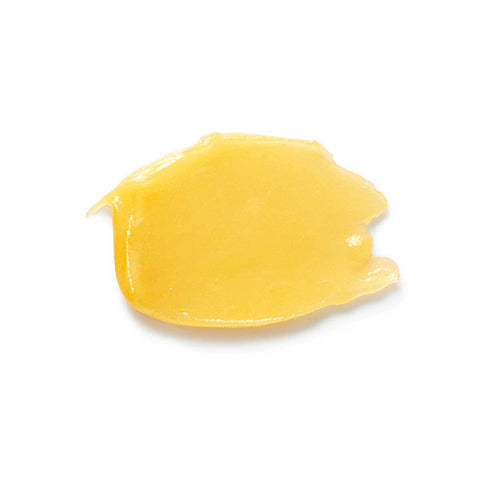 Swatch of lip balm - yellow thick texture.