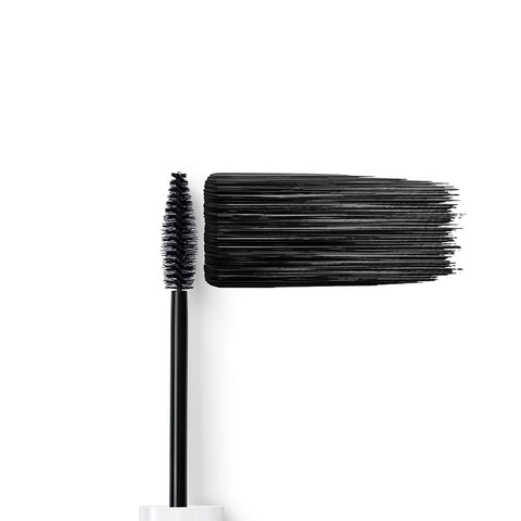 Dr. Hauschka Long-Lasting Black Mascara brush with black bristles & swatch on a white background.