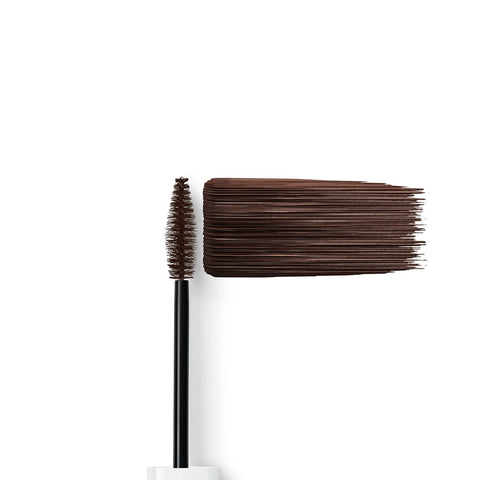 Dr. Hauschka Long-Lasting Brown Mascara brush with brown bristles & swatch on a white background.