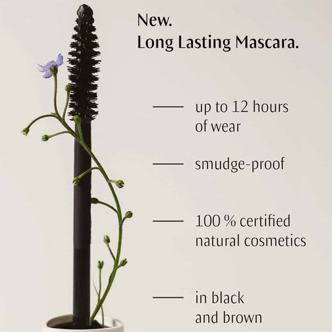 Dr. Hauschka Long-Lasting Mascara with plant-like design on a white background, featuring text about product features.