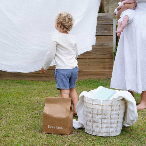 Family outside doing laundry with ease.y earth products.