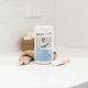 ecostore product on a bathroom counter with a white tiled wall background.