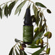 Bottle of Edible Beauty Super Stem Cell Concentrate 15ml on an olive branch with olives.