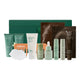A skincare gift set from Endota Organics arranged in front of a dark green box on a white background. The set includes various tubes, bottles, and a sheet mask, in shades of green and white.